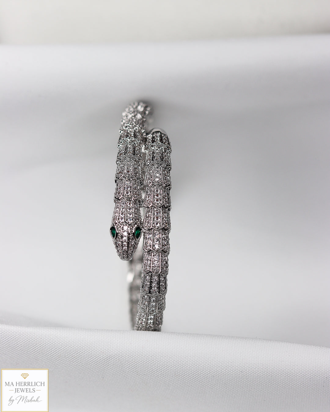 Green eyes and embellished with sparkling stones bracelet